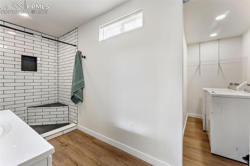 Image 21 of 42: Off the bathroom is the laundry with included washer and dryer