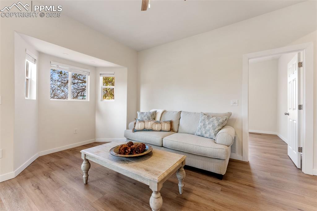 Image 6 of 42: The living room has a bump out for a loveseat couch or a spot for your ente