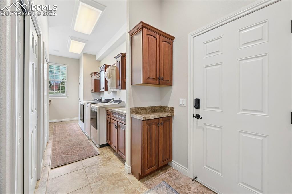 Image 24 of 50: laundry and proper mud room off garage.