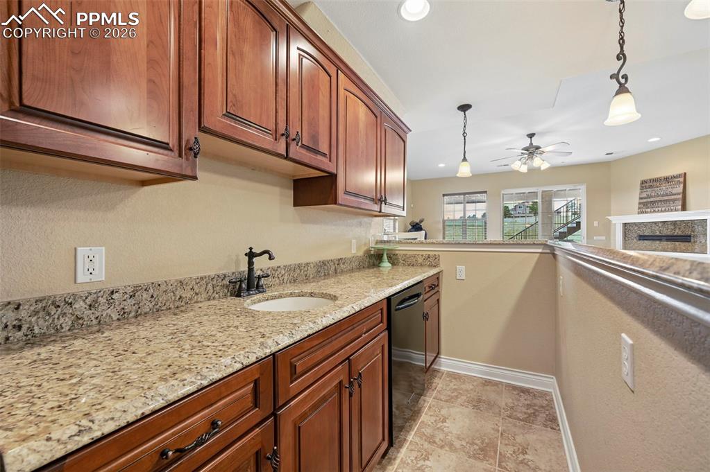 Image 40 of 50: Basement has wet bar for entertaining