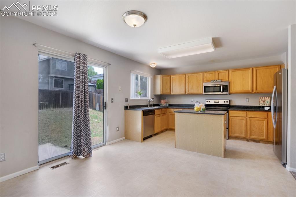 Image 12 of 37: Dining area walks out to concrete patio