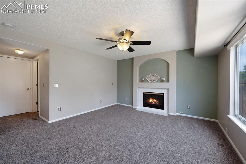 Image 15 of 37: Fireplace, new carpet, and new trim paint