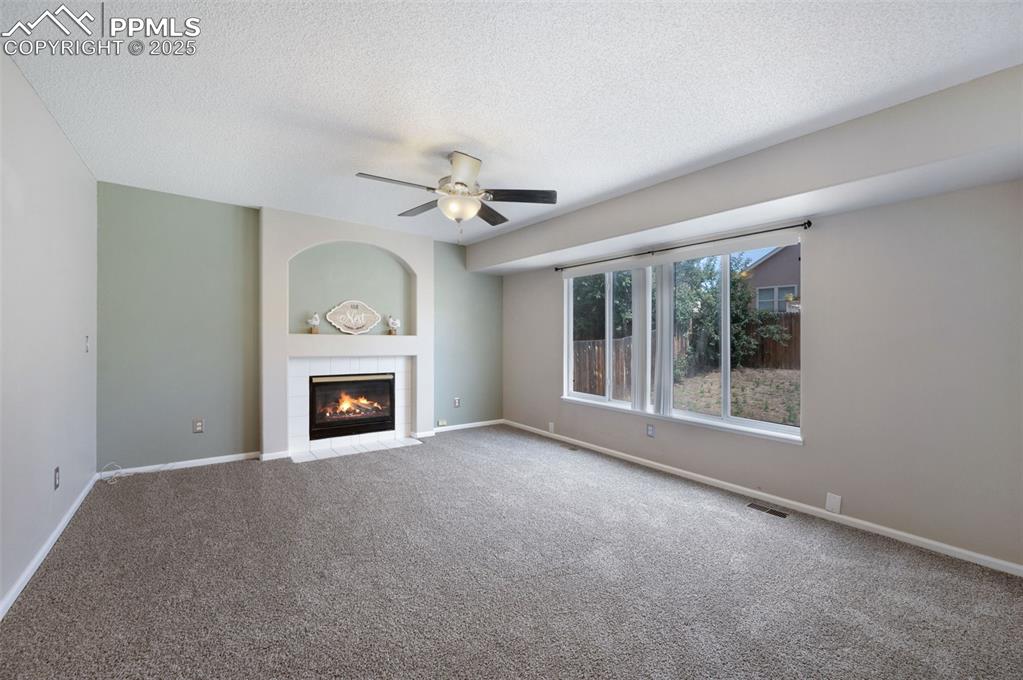 Image 16 of 37: Fireplace, new carpet, and new trim paint