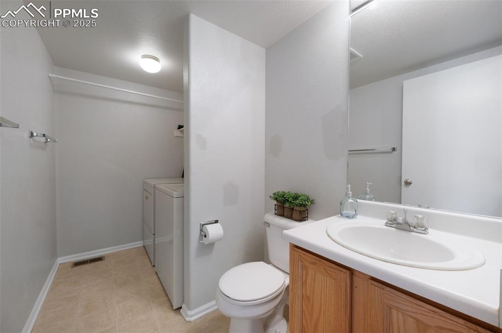 Image 17 of 37: Main level half bath with laundry