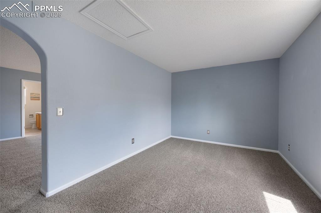 Image 21 of 37: Bonus room off the primary bedroom, new carpet, new trim paint