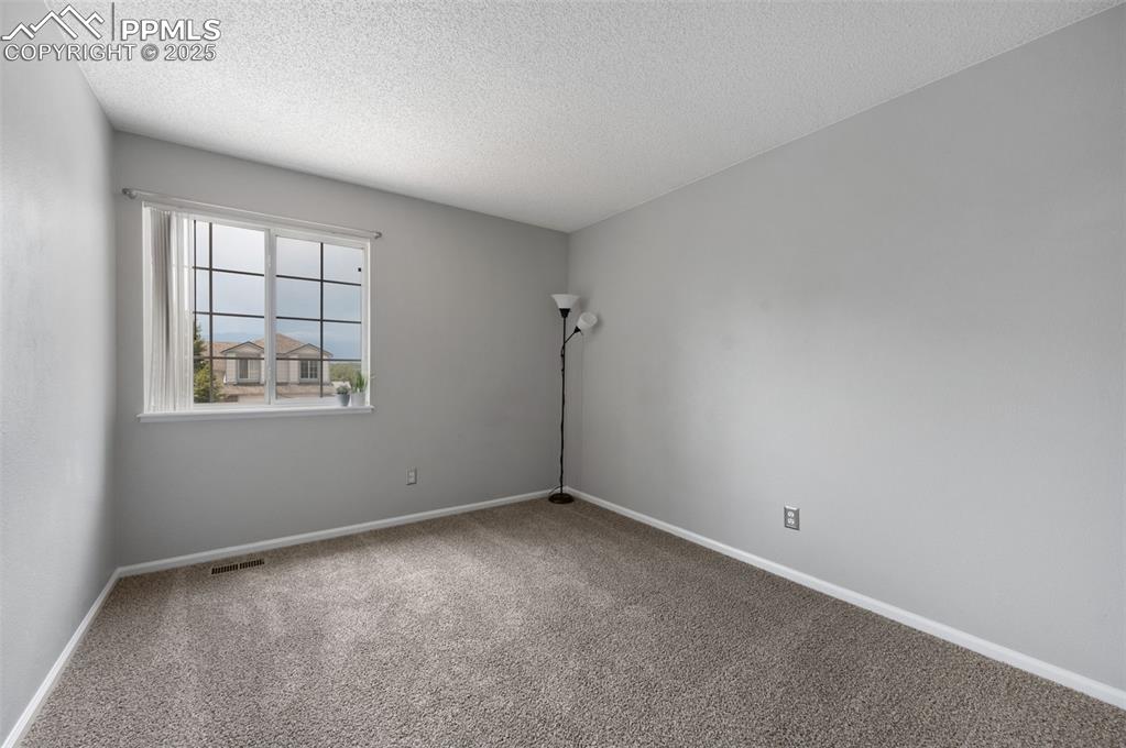 Image 24 of 37: Bedroom #2, new carpet, new trim paint, view of Pikes Peak