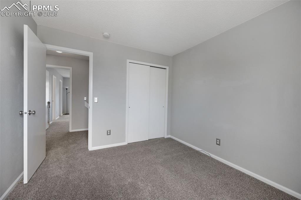 Image 30 of 37: Bedroom #3, new carpet, new trim paint, view of Pikes Peak