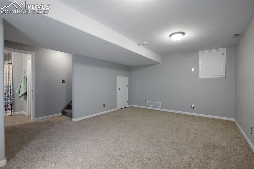 Image 31 of 37: Second family room, craft room, or potential bedroom in basement