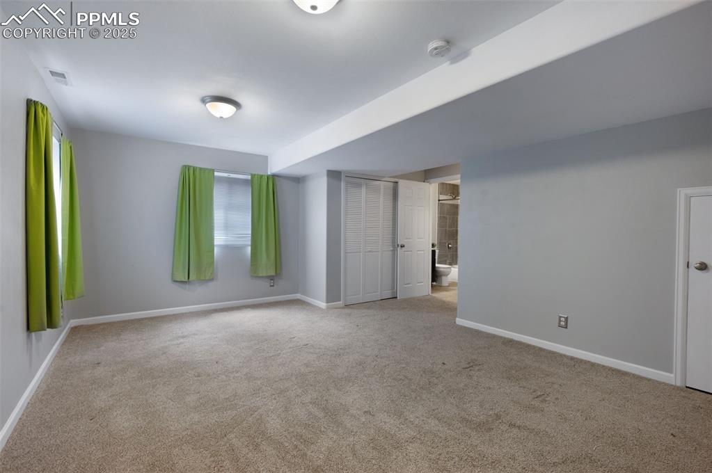 Image 32 of 37: Second family room, craft room, or potential bedroom in basement