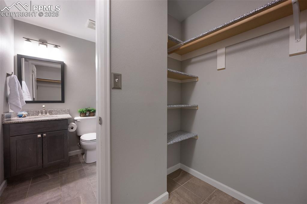 Image 34 of 37: Walk in closet off bathroom in basement