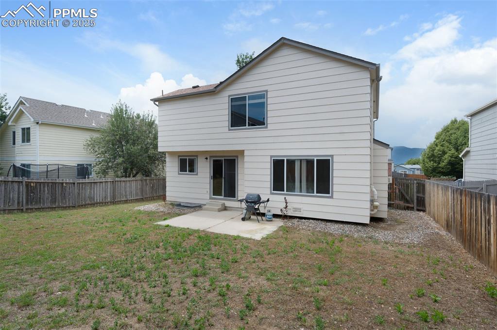Image 35 of 37: Concrete patio, spacious yard