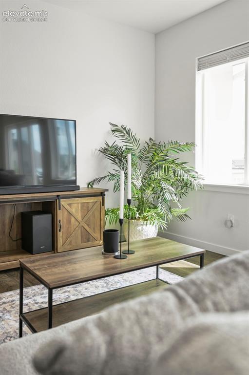 Image 12 of 38: Living room featuring baseboards