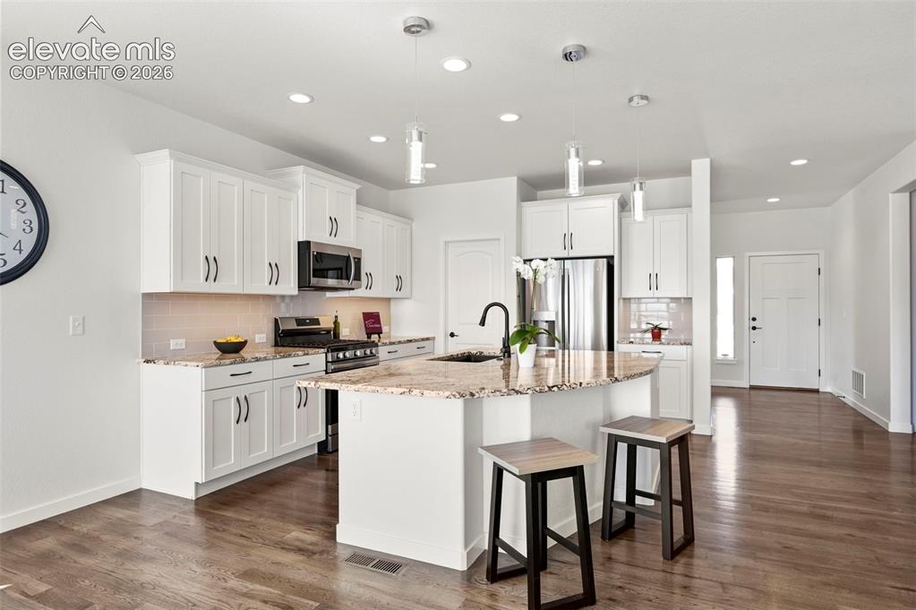 Image 13 of 38: Kitchen featuring appliances with stainless steel finishes, tasteful backsp