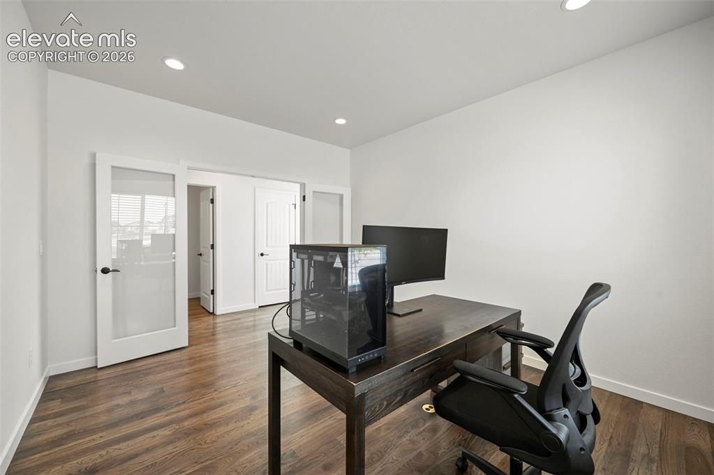Image 16 of 38: Home office featuring wood finished floors and recessed lighting