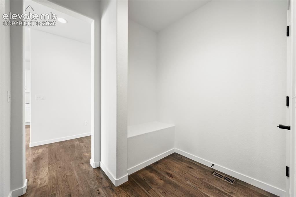 Image 18 of 38: Hallway featuring dark wood-type flooring and recessed lighting
