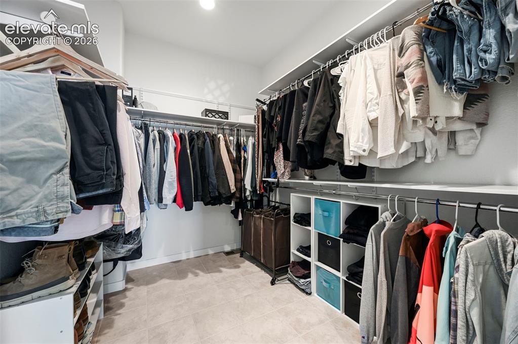Image 24 of 38: Spacious closet with tile patterned flooring