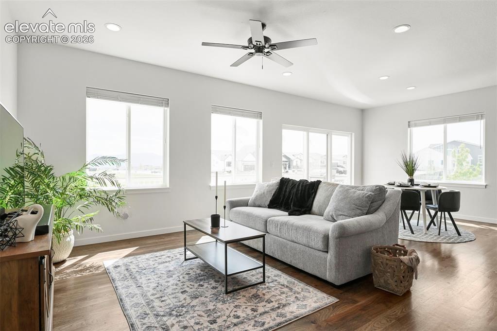 Image 9 of 38: Living area featuring healthy amount of natural light, ceiling fan, recesse
