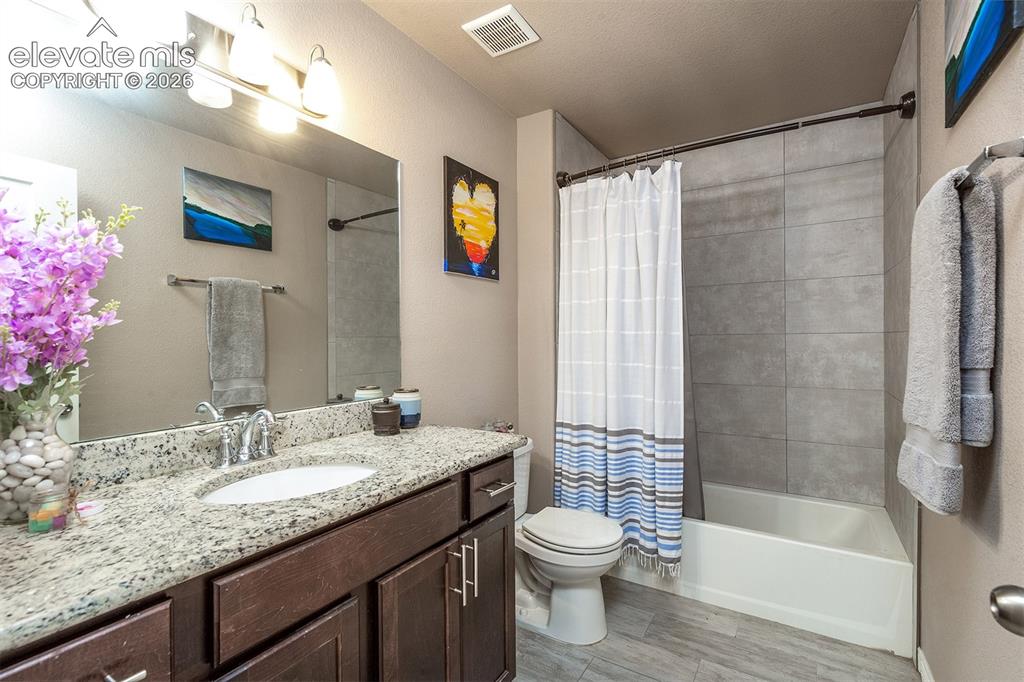 Image 32 of 45: Full bathroom featuring an oversized vanity and shower/tub combination