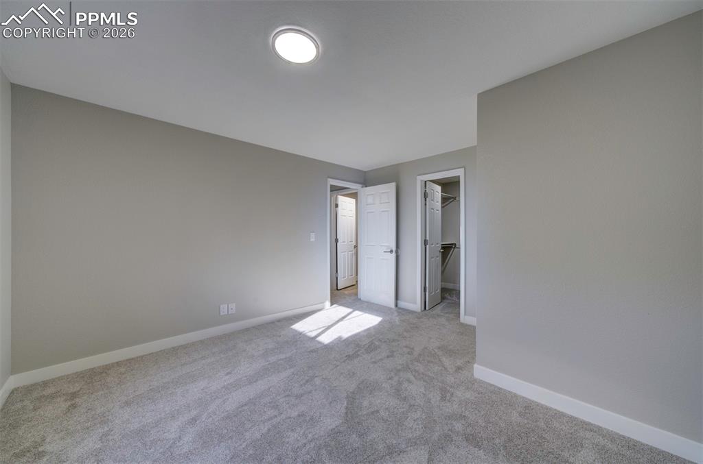 Image 28 of 33: Basement bedroom #3 with huge walk-in closet