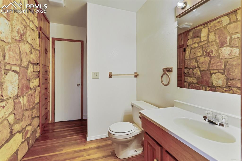 Image 17 of 35: Full bathroom with vanity and wood finished floors