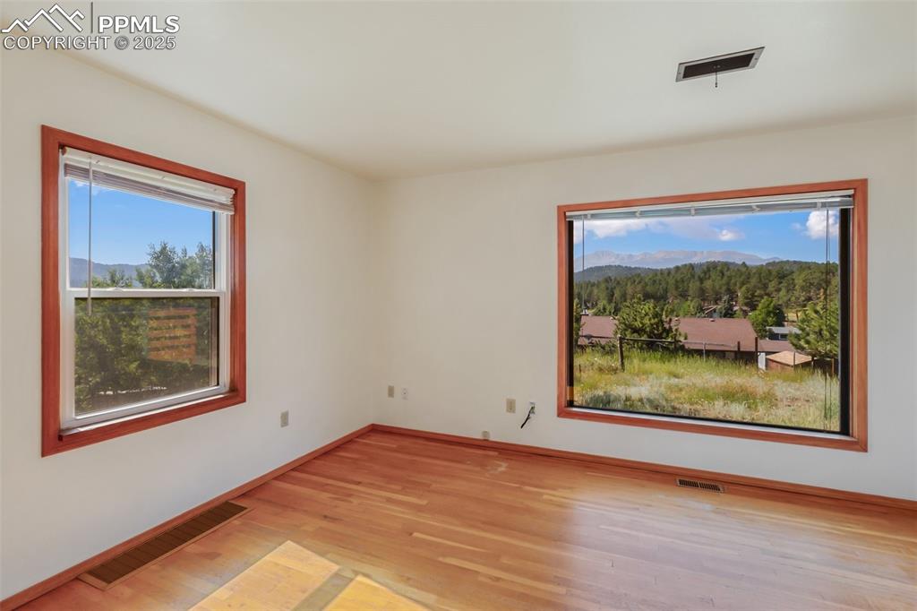 Image 19 of 35: Unfurnished room with light wood-style floors and a mountain view