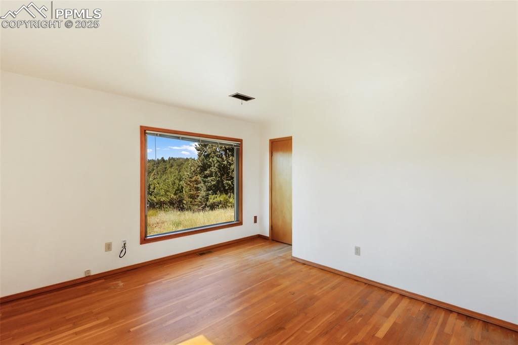 Image 20 of 35: Spare room with light wood-style floors and baseboards