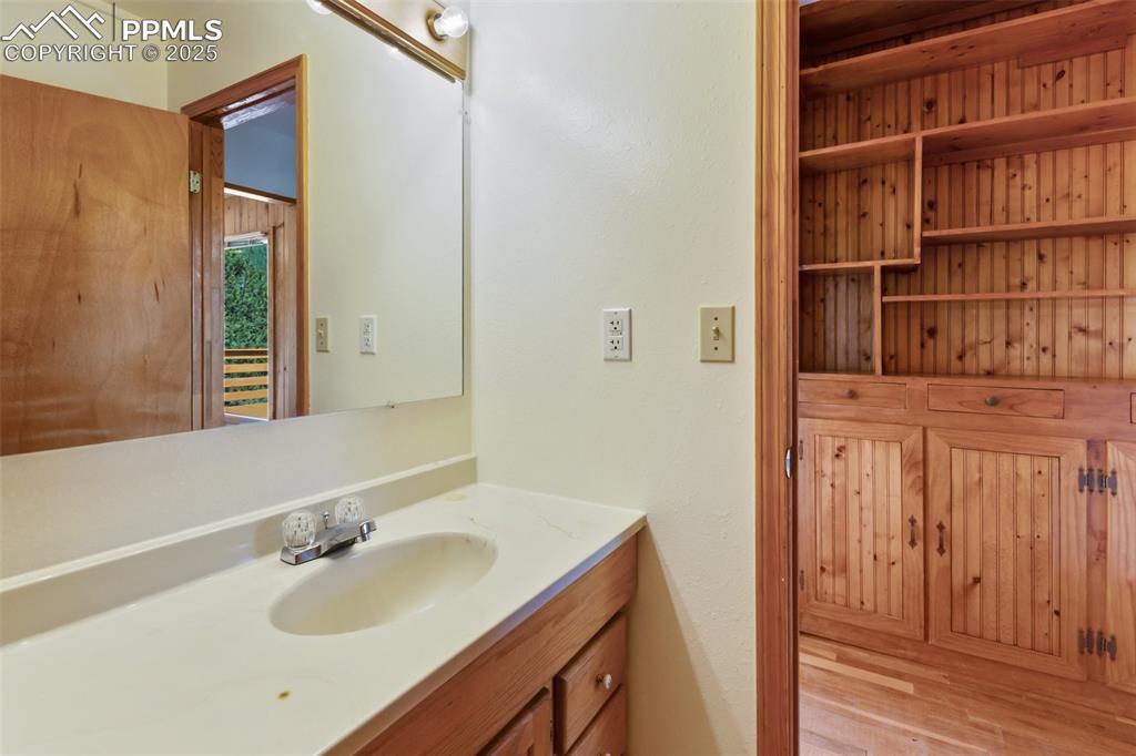 Image 25 of 35: Bathroom featuring vanity and wood finished floors