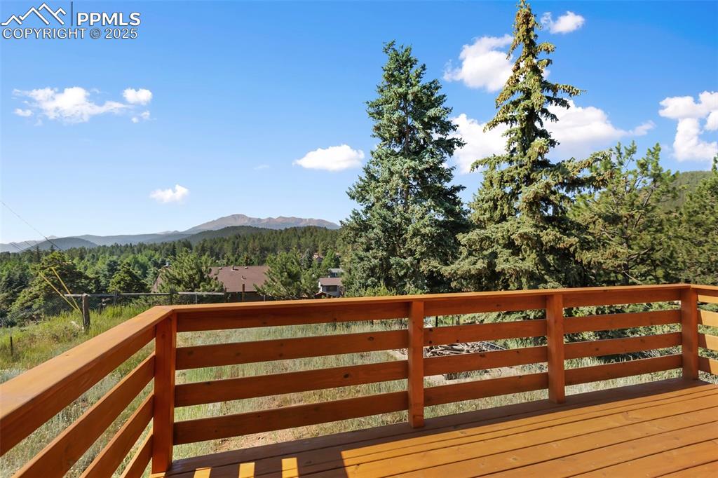 Image 4 of 35: Wooden terrace with a mountain view and a forest view