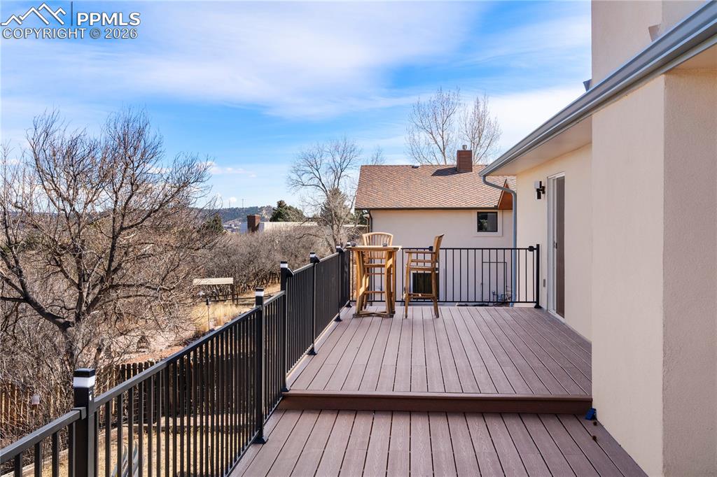 Image 12 of 46: NEW back deck overlooks the back yard and boasts stunning views.