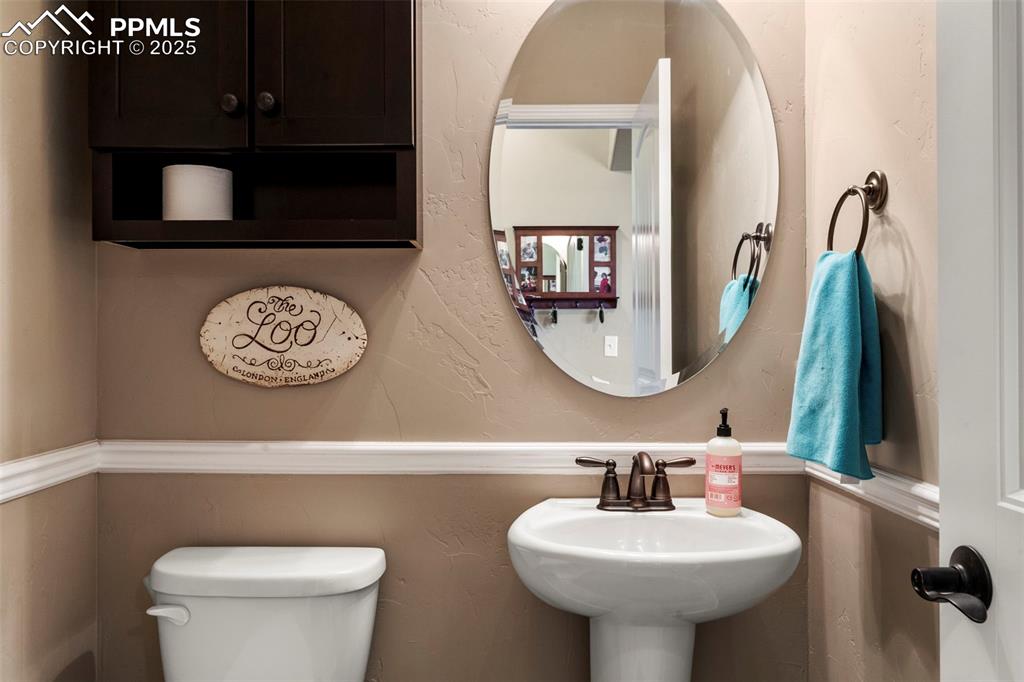 Image 21 of 41: Half bath featuring toilet and a textured wall