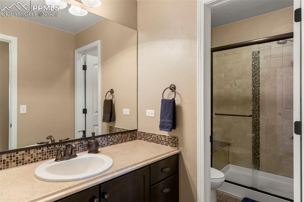Image 35 of 41: Full basement bathroom featuring vanity and a shower stall