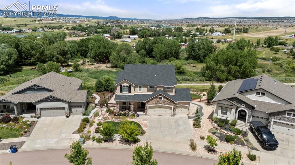 Image 6 of 41: Aerial view of property and surrounding area with a mountain backdrop