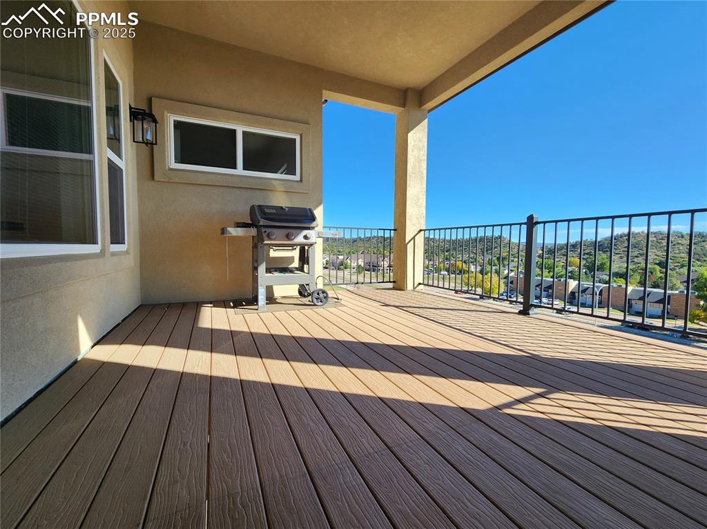 Image 10 of 50: covered balcony with durable composite flooring and elegant iron railing, o