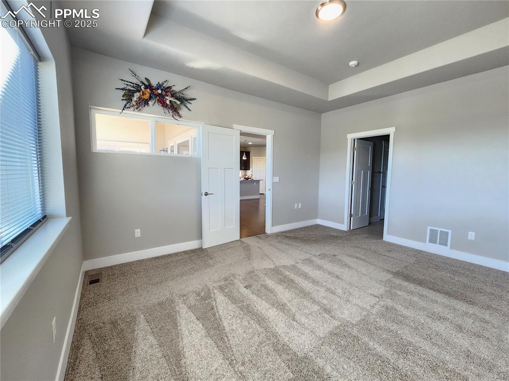 Image 14 of 50: primary suite featuring a recessed ceiling with added depth and architectur