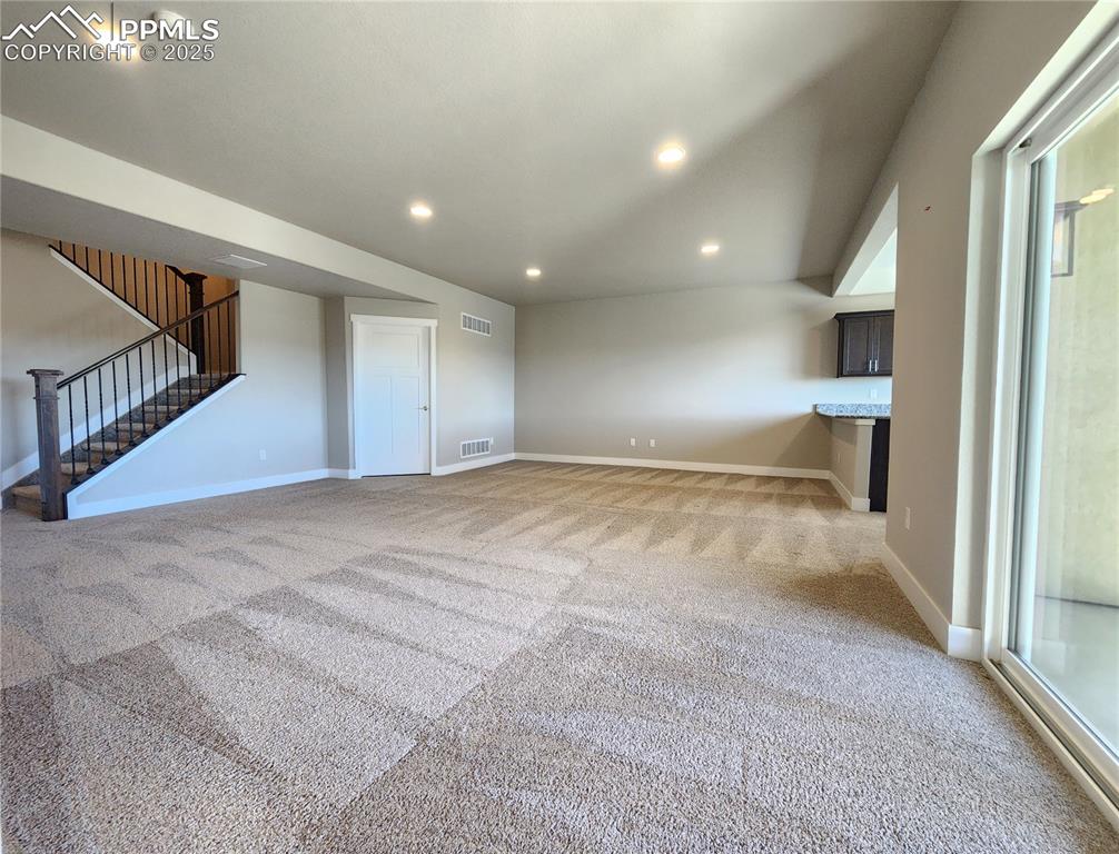 Image 25 of 50: expansive basement family room with 9-foot ceiling