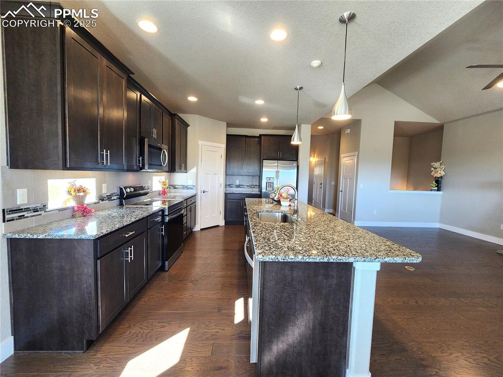 Image 6 of 50: gourmet kitchen featuring granite countertops, a large island perfect for p