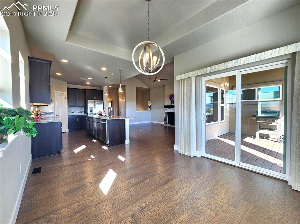 Image 9 of 50: open dining area connected to kitchen, with sliding door access to balcony