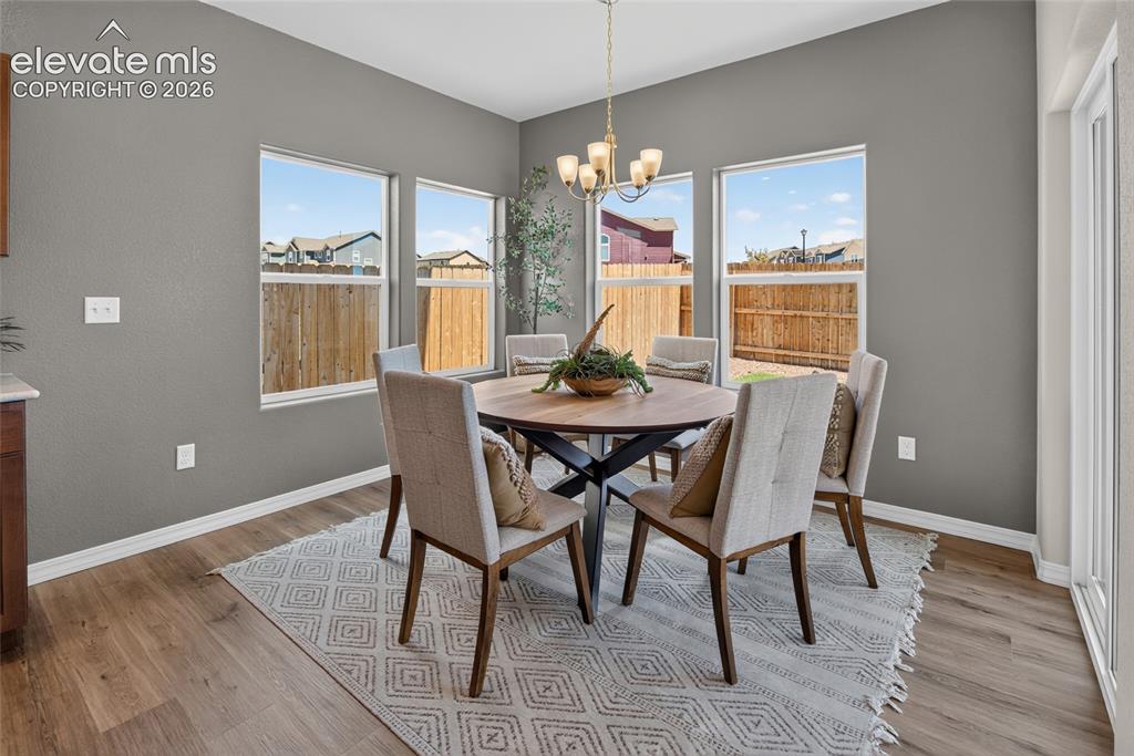 Image 17 of 45: Kitchen featuring wood-finish flooring, light-toned countertops, and a gray