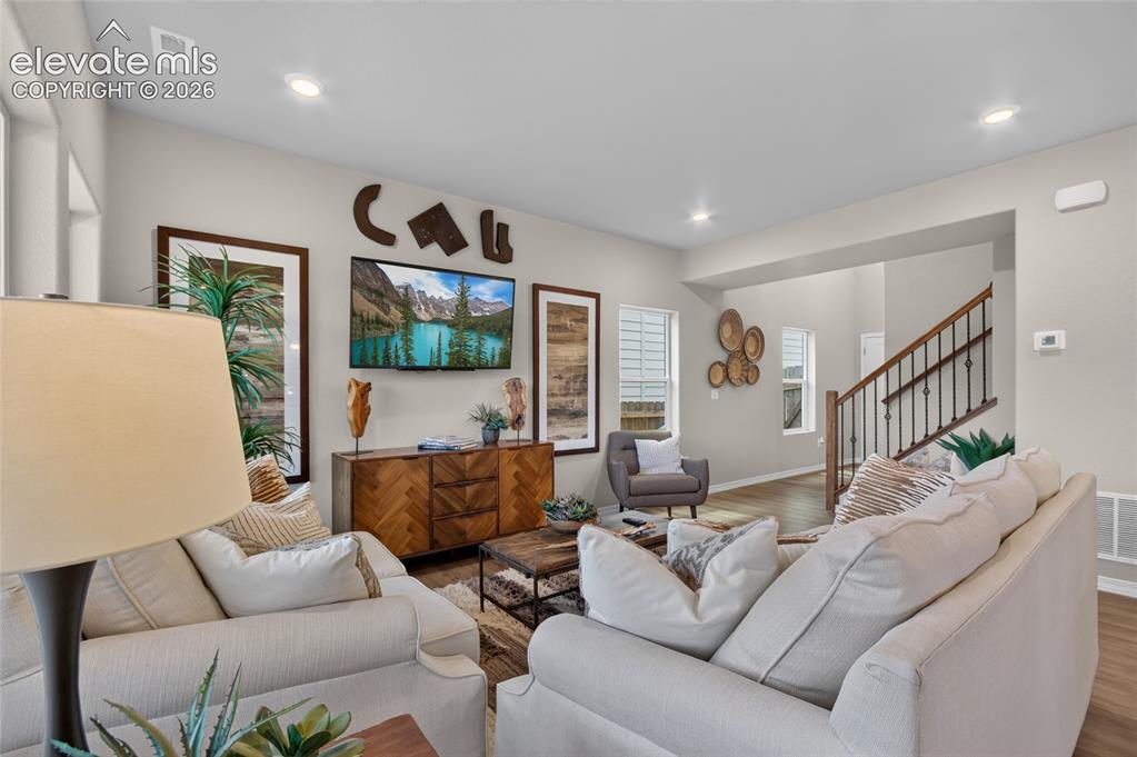 Image 18 of 45: Dining space featuring gray walls, wood-finish flooring, and a multi-light