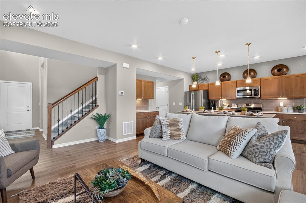 Image 19 of 45: Spacious living area featuring recessed lighting, light neutral wall tones,