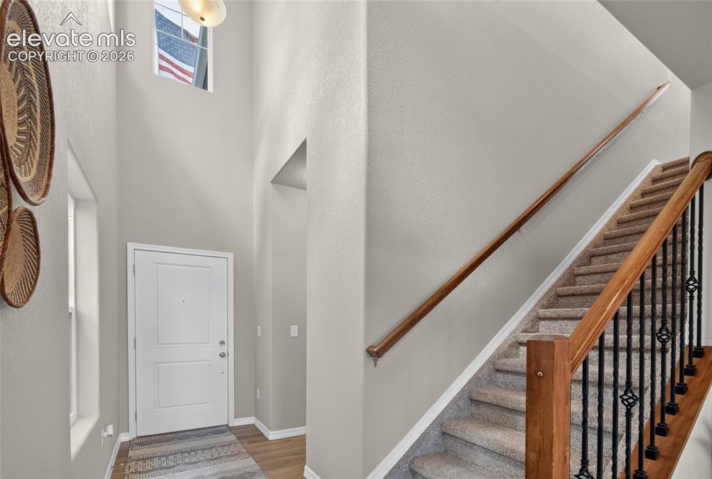 Image 20 of 45: Open-concept living area featuring wood-finish flooring, recessed lighting,