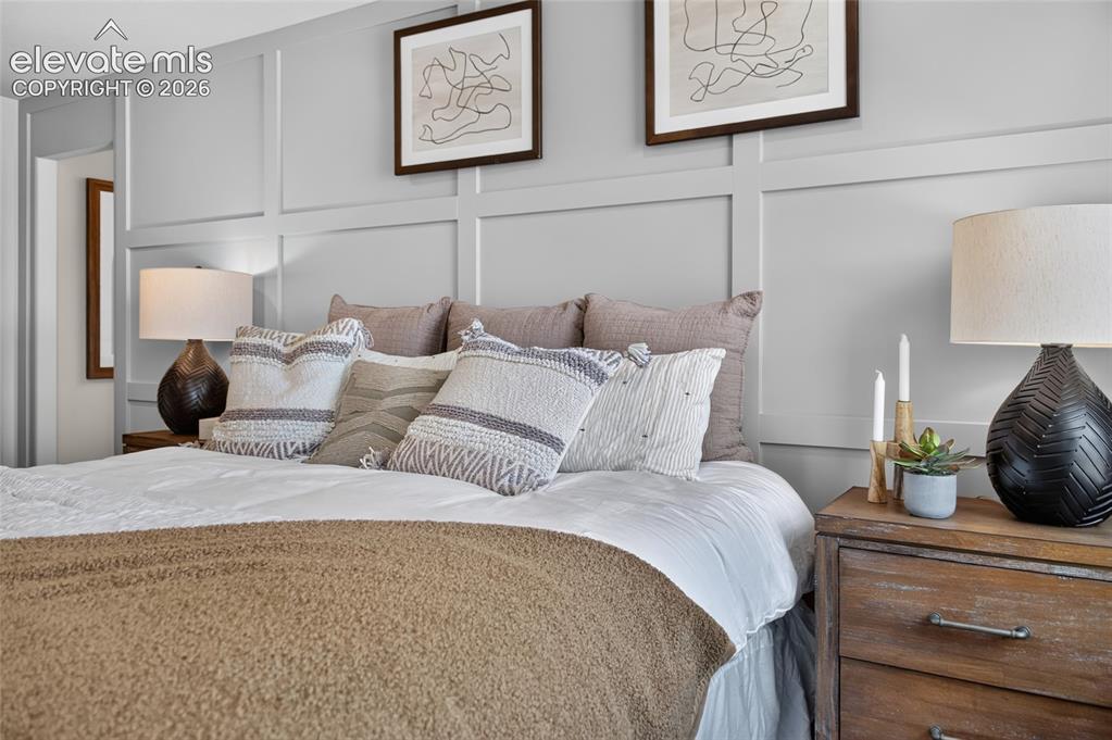 Image 25 of 45: Bedroom featuring board and batten accent wall, recessed lighting, and soft