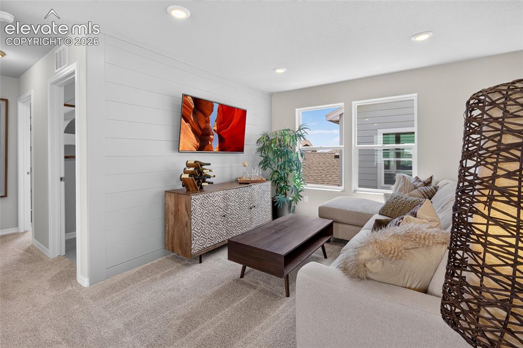 Image 32 of 45: Dedicated utility space featuring neutral-toned walls, tile flooring, and a