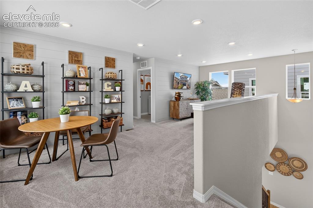 Image 33 of 45: Living area featuring shiplap accent wall, recessed lighting, and soft neut