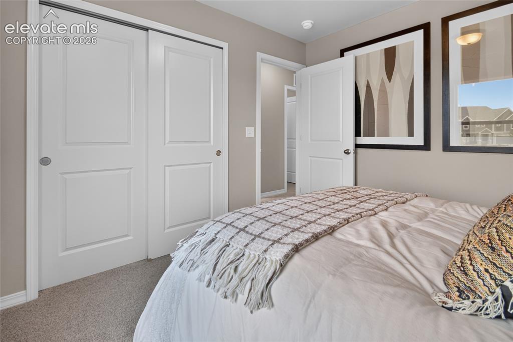 Image 35 of 45: Bedroom featuring soft carpet flooring, light neutral-toned walls, a white-