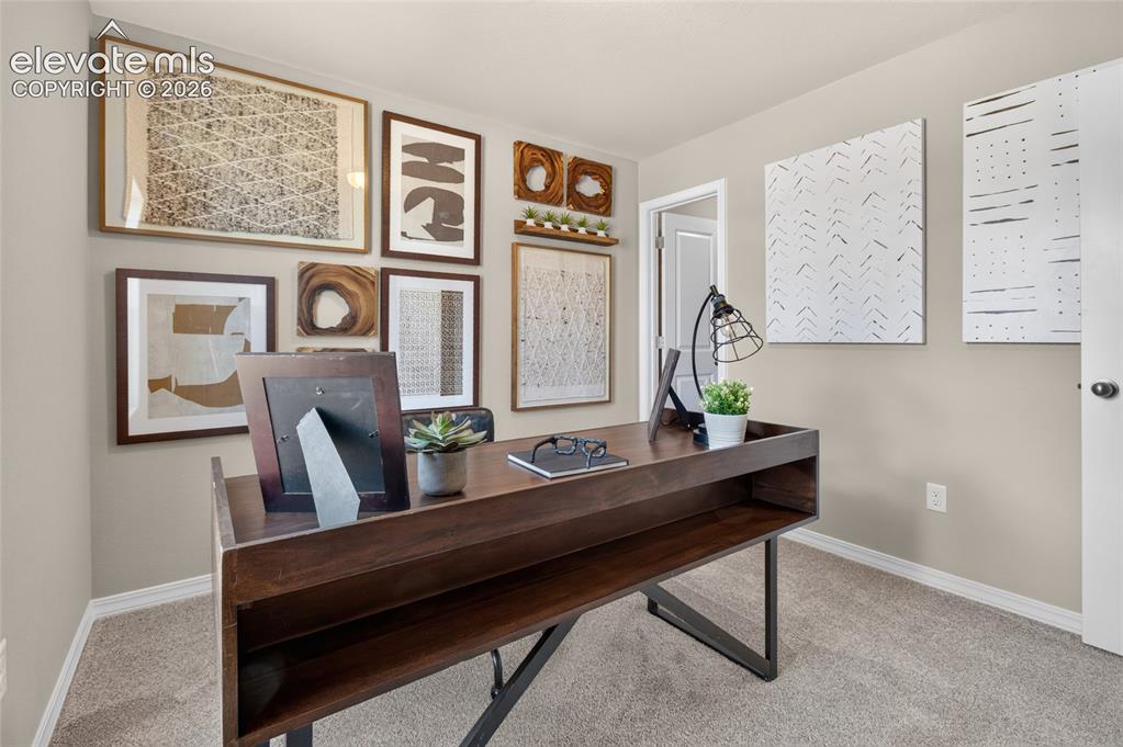 Image 38 of 45: Carpeted room featuring a window with exterior views, a built-in wall vent,