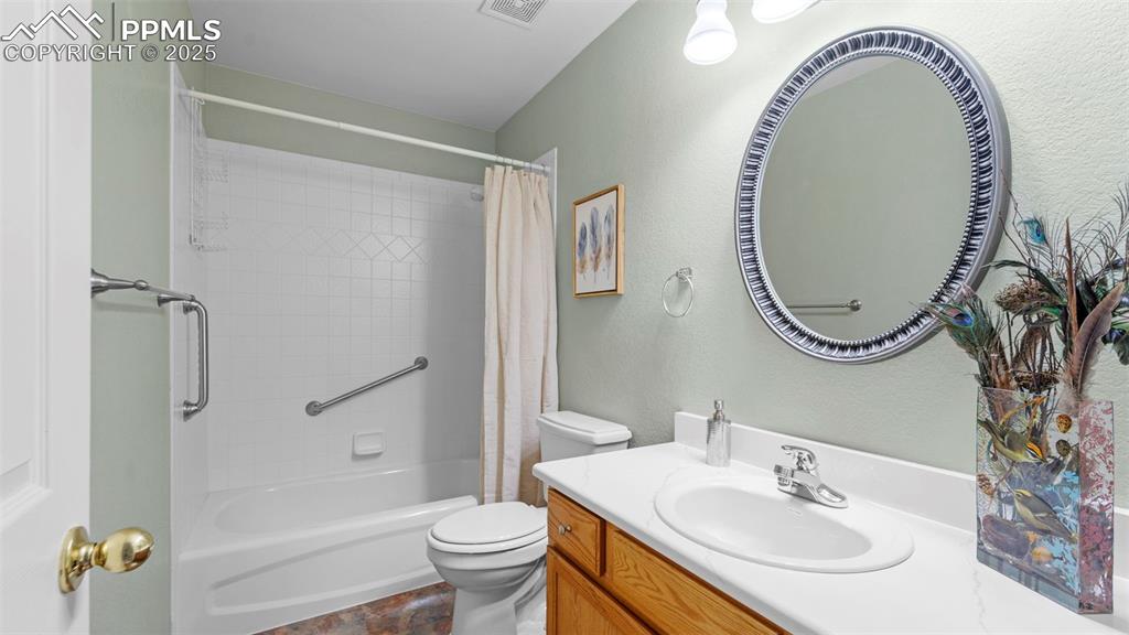 Image 15 of 33: Full bathroom featuring shower / bathtub combination with curtain, vanity, 