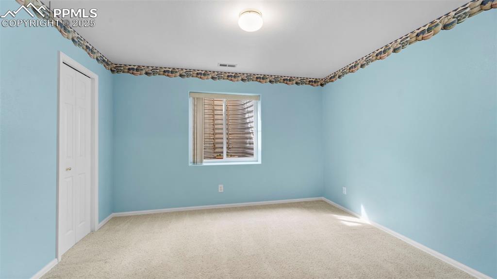 Image 25 of 33: Empty room featuring carpet and baseboards