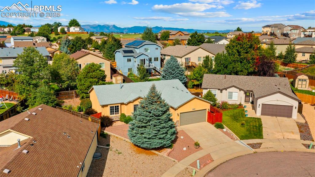Image 29 of 33: Aerial view of residential area featuring mountains