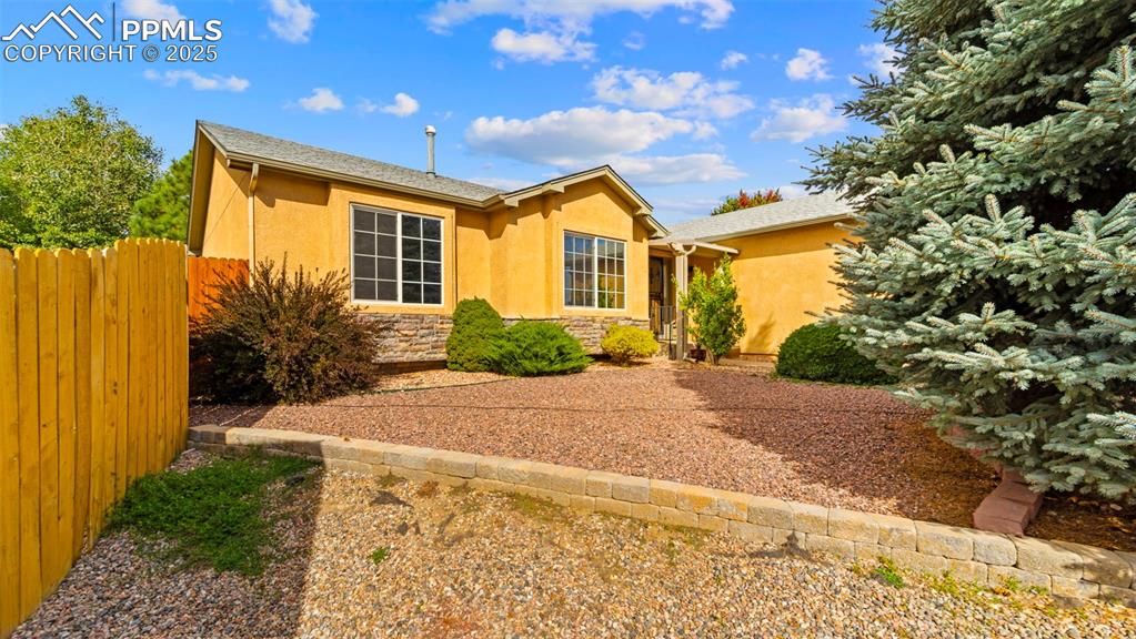 Image 4 of 33: View of front facade featuring stone siding and stucco siding